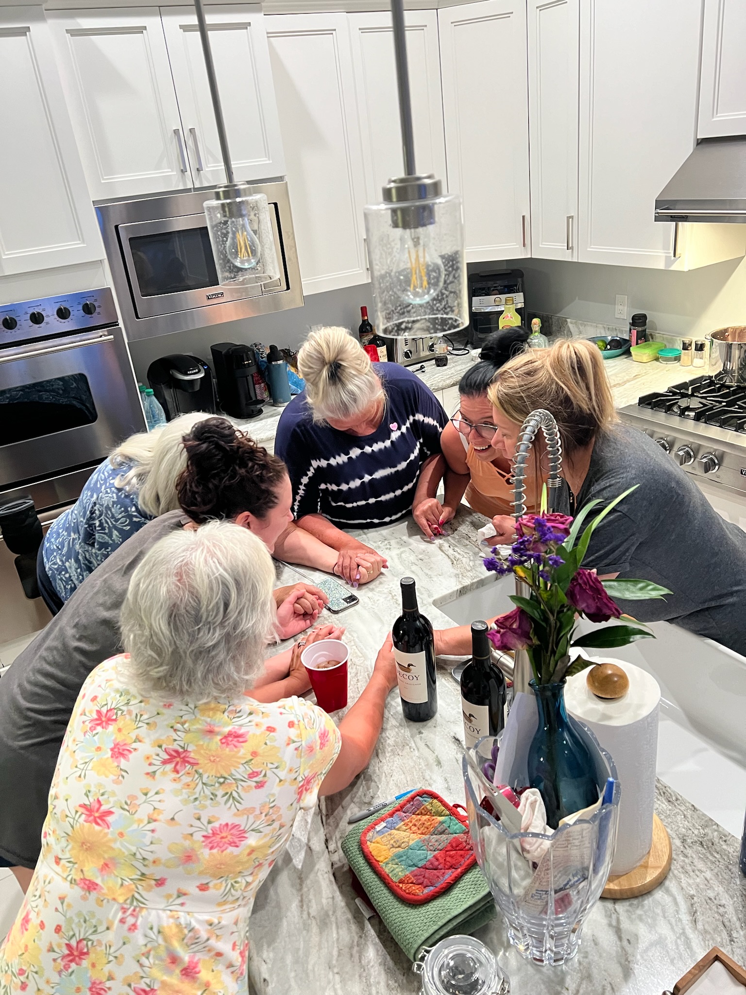 Family gathered together around a kitchen island