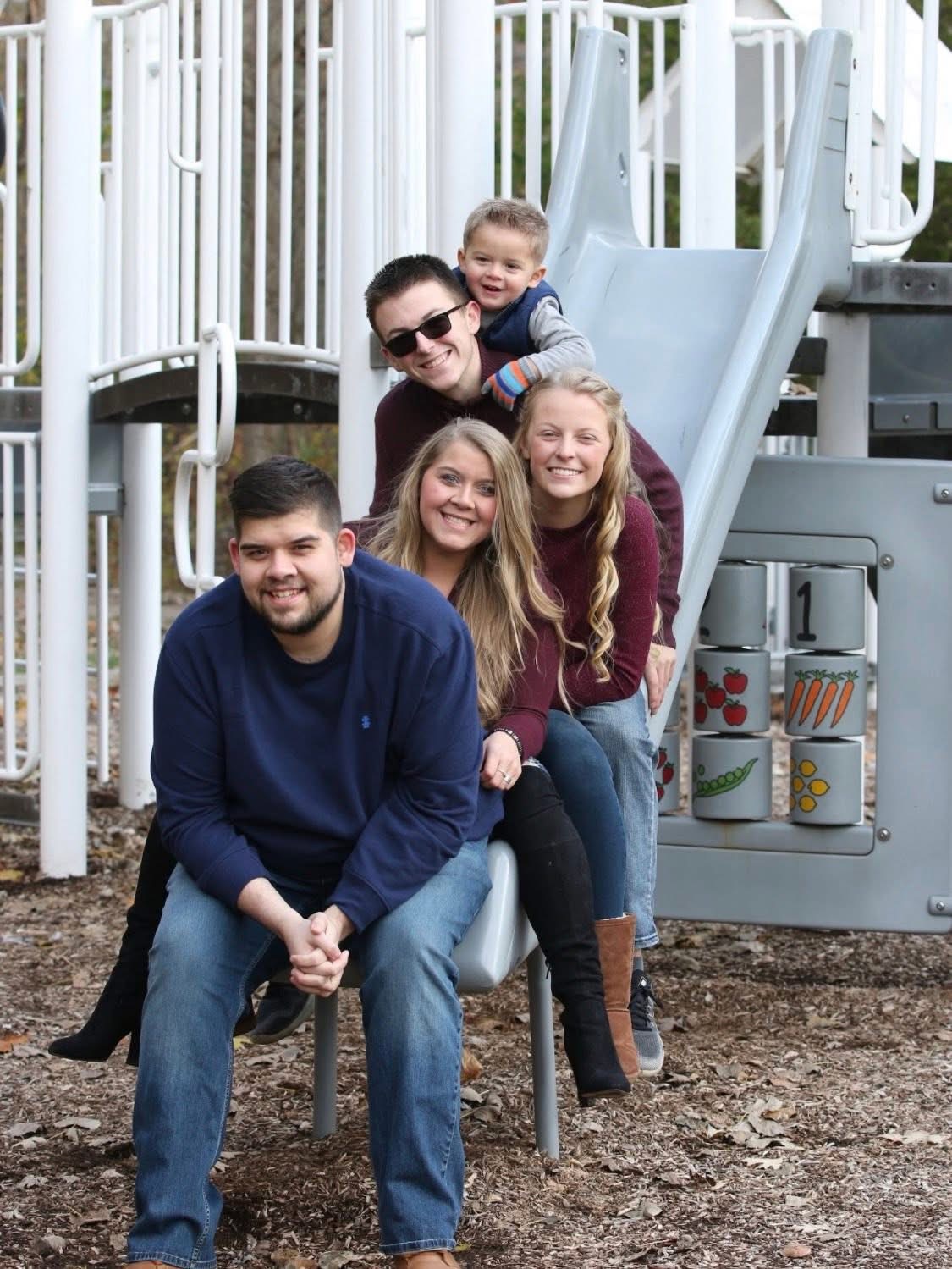 Tina's children and grandbaby together at a playground